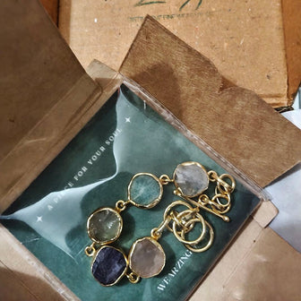 Gold bracelet with gemstones in a 'Wear Zing' box